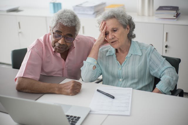 Advisor and client reviewing tax documents and retirement projections
